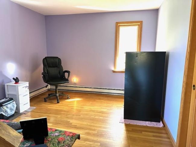 Office featuring a baseboard radiator and light wood-type flooring | Image 15