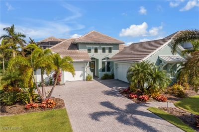 Front view of property featuring a 2 car garage and a 1 car. Note the beautiful landscaping. | Image 1