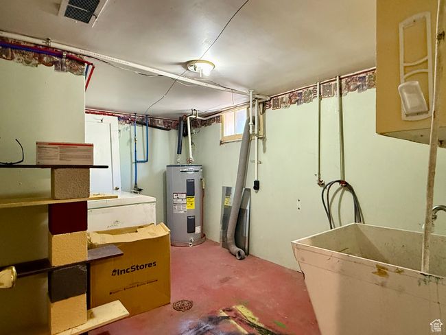Basement with electric water heater and a sink | Image 41