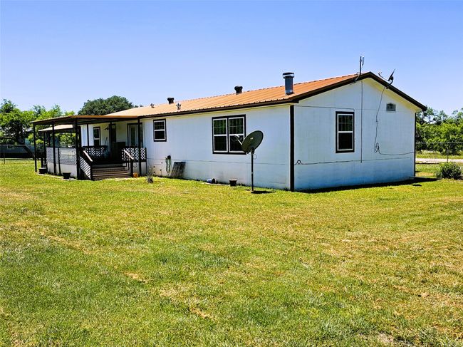 Rear view of property with a lawn and metal roof | Image 24