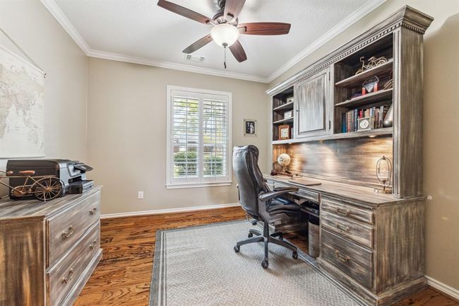 The home office features abundant natural light and custom barn doors for privacy. | Image 11