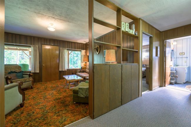 Hall featuring carpet floors, wooden walls, and a textured ceiling | Image 24