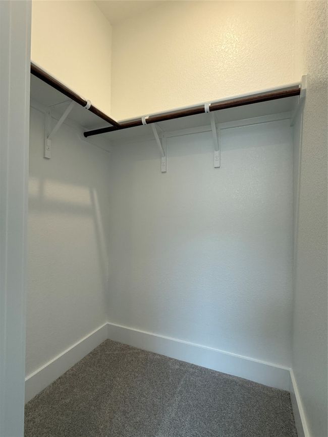 Spacious closet with carpet floors | Image 9
