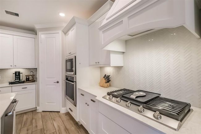 The 5 burner gas cooktop and herringbone tile backsplash is classic, stunning and looks like new! | Image 14