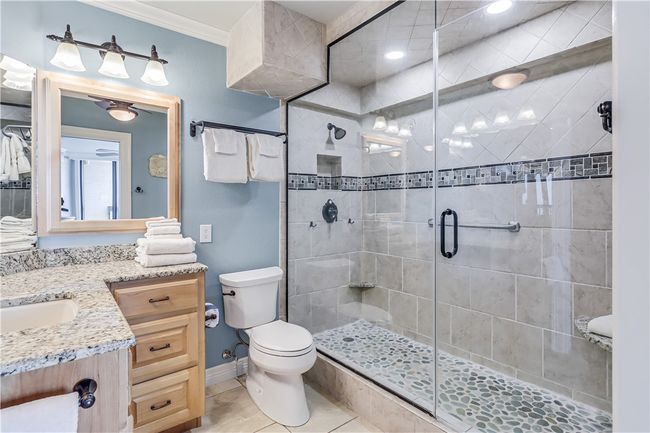 Master bathroom with walk in tiled shower and granite counters. | Image 24