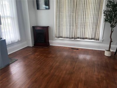 Unfurnished living room featuring dark hardwood / wood-style floors | Image 3