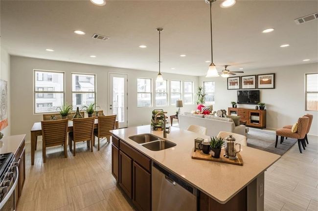 Kitchen with appliances with stainless steel finishes, healthy amount of natural light, recessed lighting, light countertops, and decorative light fixtures | Image 11