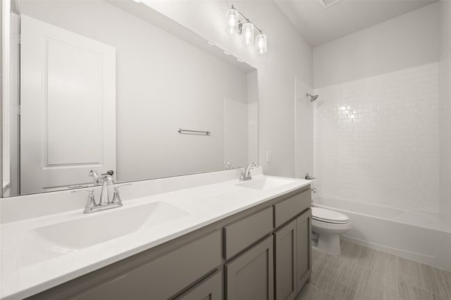 Full bath with toilet, double vanity, and bathtub / shower combination | Image 23