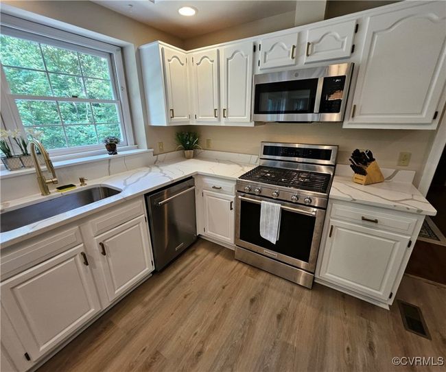 Kitchen featuring newer stainless steel appliances, and ornamental molding | Image 19