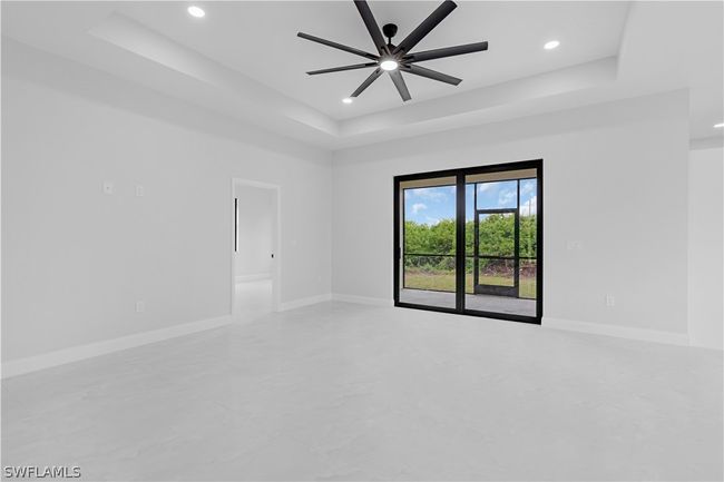 Spare room with tile flooring, ceiling fan, and a raised ceiling | Image 30