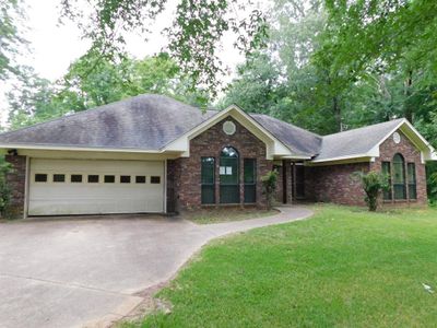 Ranch-style house with a garage and a front yard | Image 1