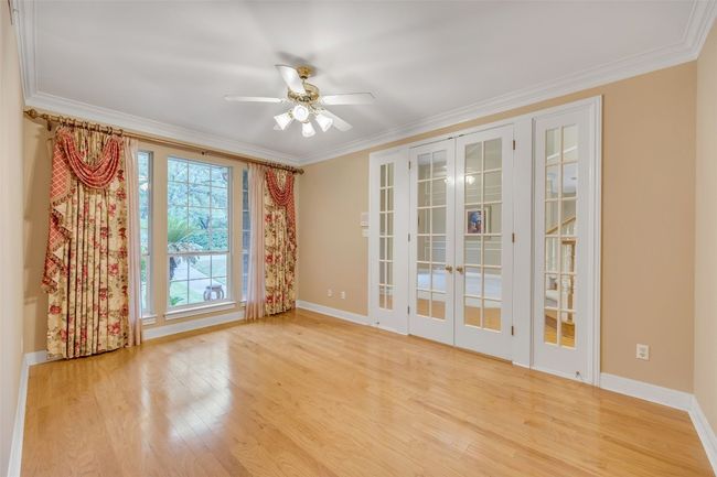 Empty room featuring french doors, ornamental molding, light wood finished floors, and ceiling fan | Image 11