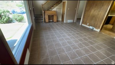 Unfurnished living room featuring dark tile floors | Image 2