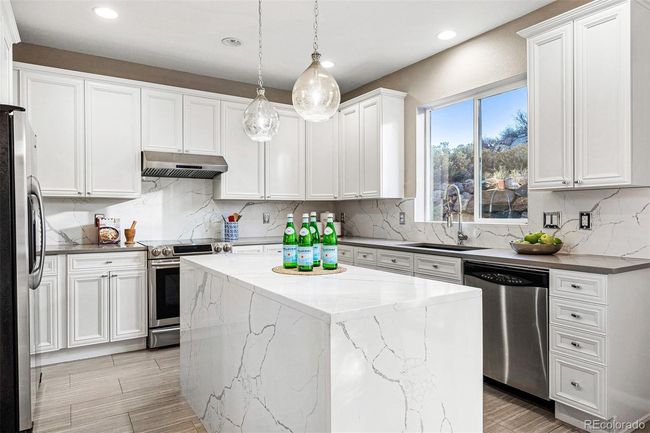 Beautifully updated kitchen with sophisticated waterfall kitchen island | Image 10