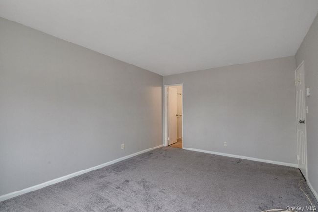 Empty room with baseboards and carpet floors | Image 18