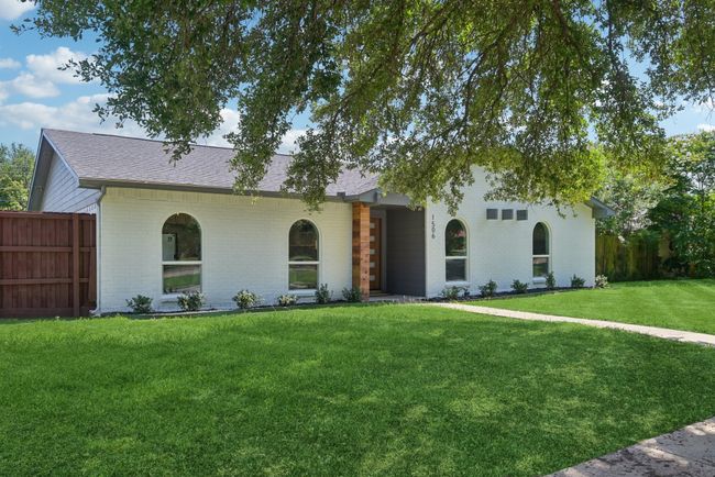 View of front of house featuring brick siding and roof with shingles | Image 5