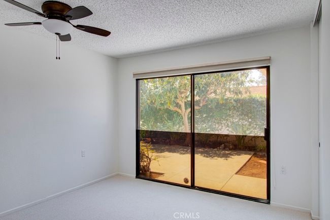Guest bedroom #1 has direct access to the front courtyard. | Image 23