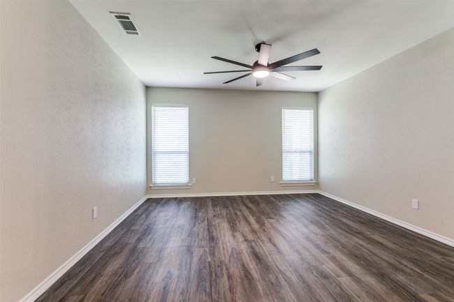Empty room with ceiling fan and dark wood-type flooring | Image 20