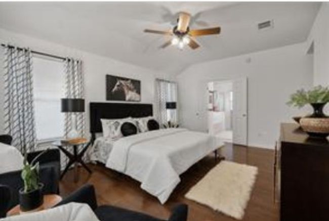 Bedroom with ceiling fan, wood finished floors, and lofted ceiling | Image 30