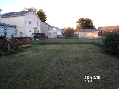 View of yard with a storage shed and a wooden deck | Image 3