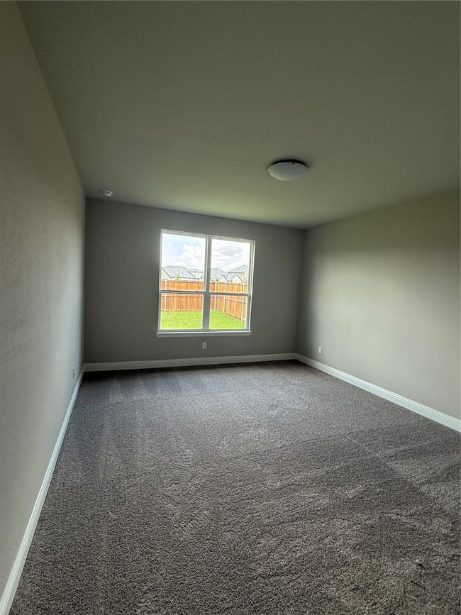 Carpeted empty room featuring baseboards | Image 12