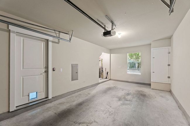 Garage with a garage door opener and electric panel | Image 9