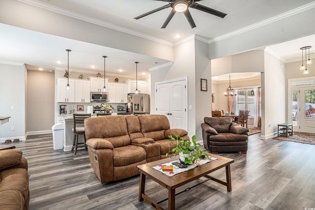 Living room featuring baseboards, a ceiling fan, dark wood finished floors, crown molding, and recessed​​‌​​​​‌​​‌‌​‌‌​​​‌‌​​‌‌​‌​​​​​‌ lighting | Image 16
