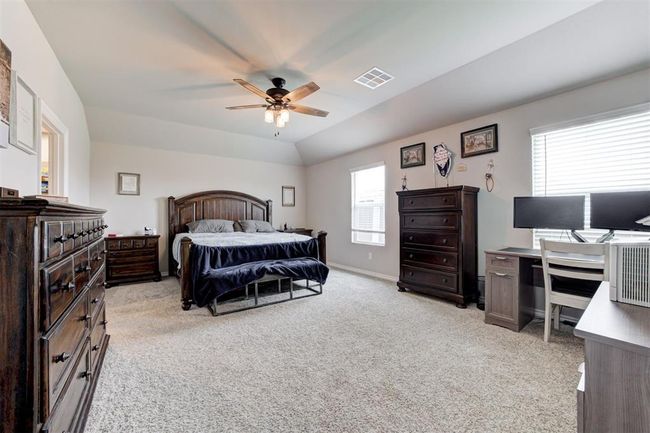 Bedroom featuring light carpet, lofted ceiling, a desk, and ceiling fan | Image 20
