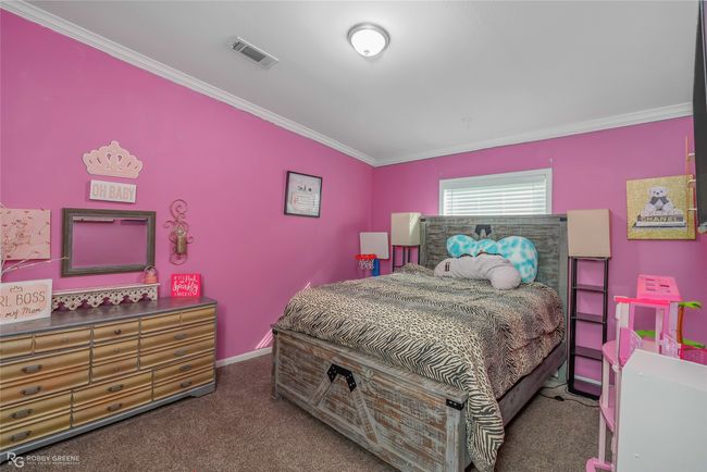 Bedroom featuring carpet, visible vents, ornamental molding, and baseboards | Image 31