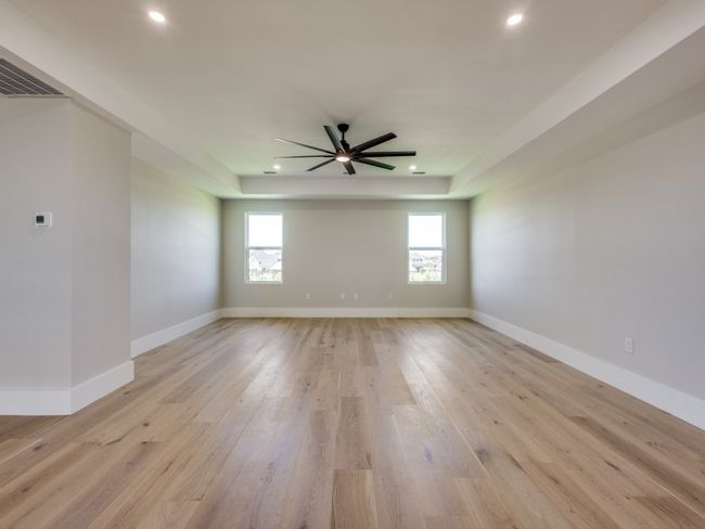 Unfurnished large upstairs game room-media with recessed lighting, a ceiling fan, light wood-style flooring, a raised ceiling, and built in cabinets (not pictured) | Image 39