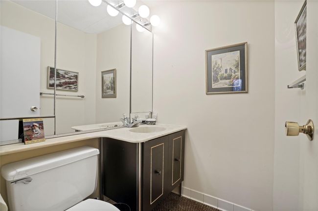 Bathroom with toilet, tile patterned floors, and vanity | Image 16