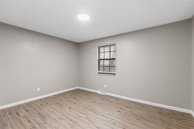 Empty room featuring baseboards, visible vents, and light wood finished floors | Image 18