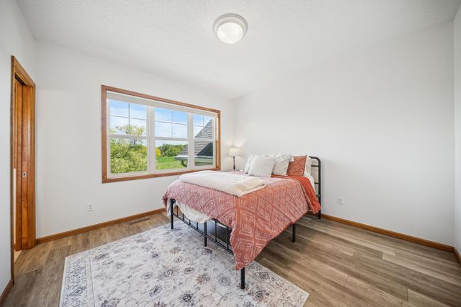 Upstairs are three bedrooms, including a spacious primary suite and laundry. | Image 28