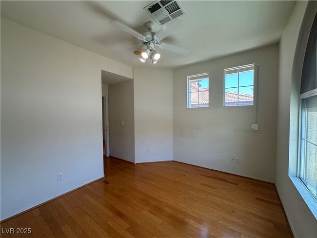 Spare room with light wood-style flooring and a ceiling fan | Image 8