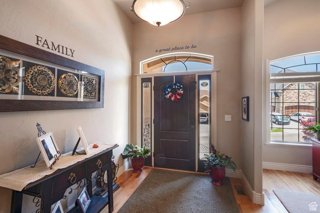 Foyer featuring light wood finished floors and a towering ceiling | Image 4