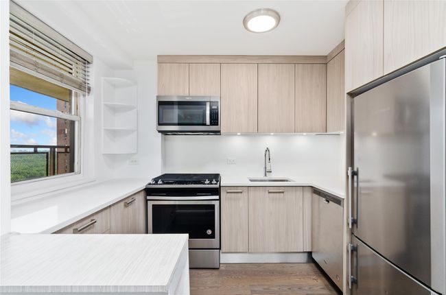 Kitchen with stainless steel appliances, light brown cabinetry, and modern cabinets | Image 14