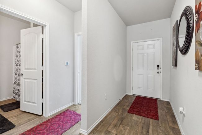 Foyer with wood-vinyl finished floors and baseboards | Image 8