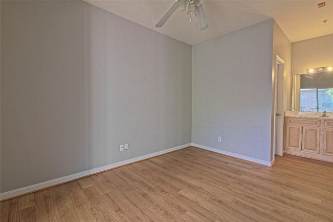 Spare room with light wood-style floors and ceiling fan | Image 23