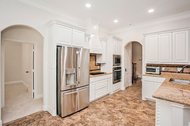 Dining space withcrown molding, a chandelier, and natural light. | Image 7