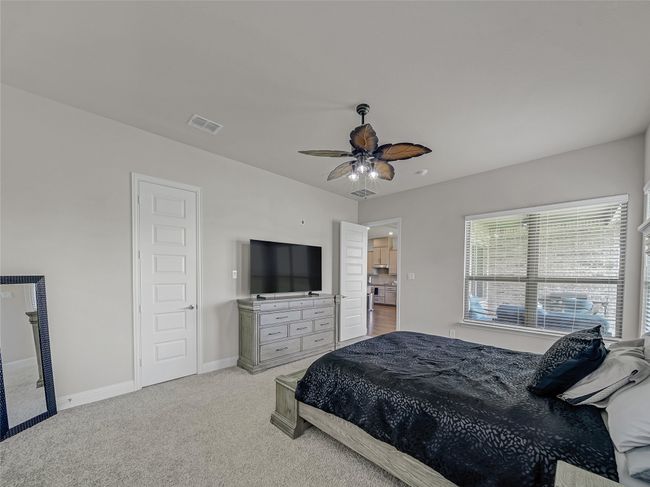 Carpeted bedroom with a heating unit and ceiling fan | Image 20