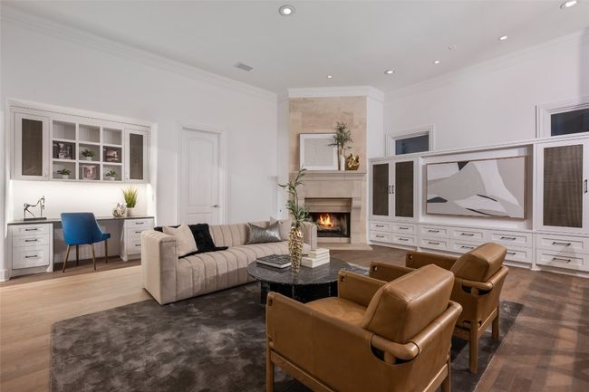 Living area with ornamental molding, wood finished floors, a fireplace, and recessed lighting | Image 7