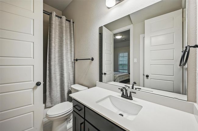 Bathroom featuring vanity, a textured wall, and ensuite bath | Image 10