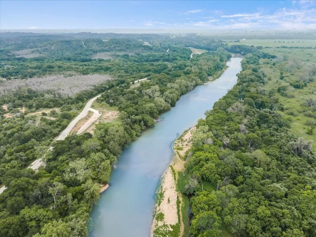 Birds eye view of property featuring a forest view and a water view | Image 35