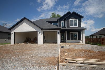 Beautifully crafted wood beams accent the ceiling, creating a cozy and inviting atmosphere. | Image 1