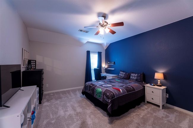 Carpeted bedroom featuring lofted ceiling and a ceiling fan | Image 30