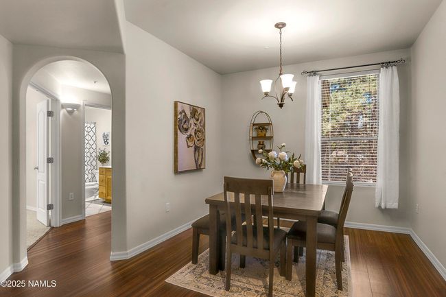 Enjoy a meal in the dining space accompanied by ample light. | Image 6