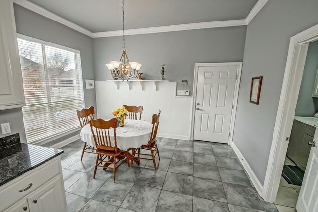Breakfast area open to kitchen and open the windows to hear the courtyard fountain! Back door leads to garage. The door to the right leads to spacious laundry room | Image 15