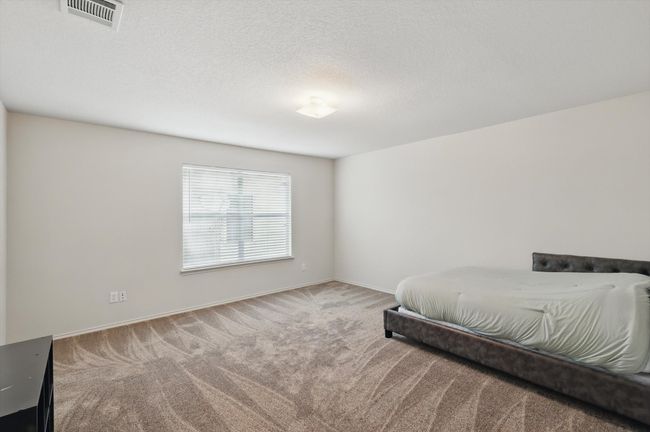 Carpeted bedroom with baseboards and a textured ceiling | Image 23