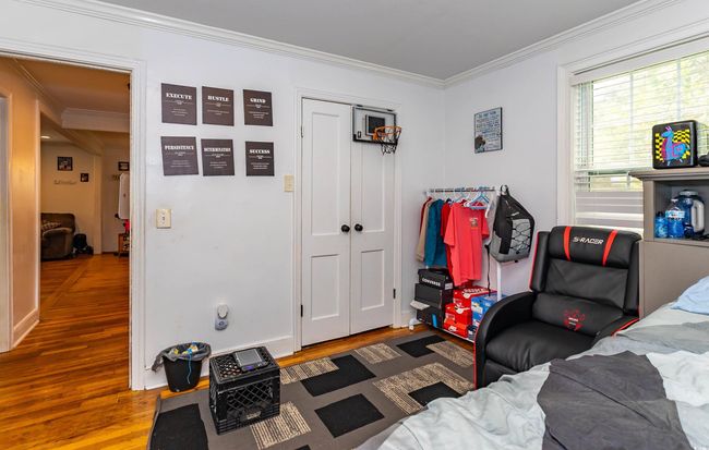 Sitting room with crown molding and wood finished floors | Image 11