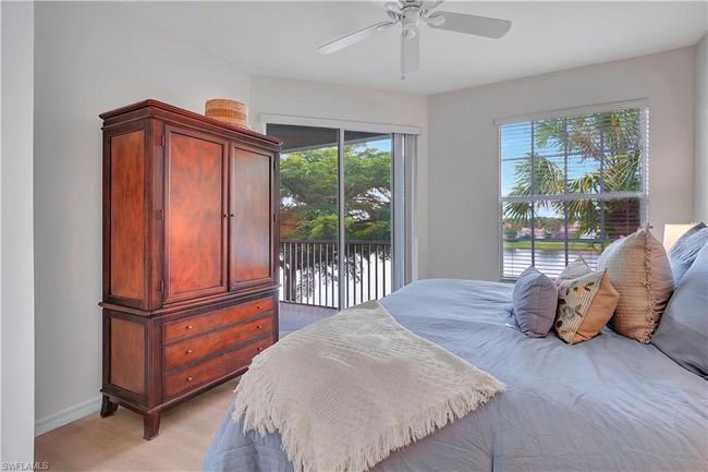 Master Bedroom with light wood-type flooring, a water view, ceiling fan, and access to exterior | Image 15